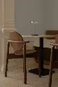UMAGE_lifestyle_Heiko_dining-chair_walnut_Gather_café-table_travertine_(4).webp